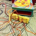 mixed media assemblage: old wood cabinet, wooden utensils, painted sticks, collage, acrylic paint, watercolor