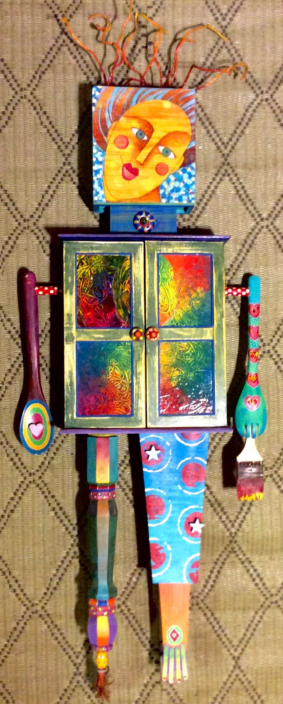 mixed media assemblage: old wood cabinet, wooden utensils, painted sticks, collage, acrylic paint, watercolor